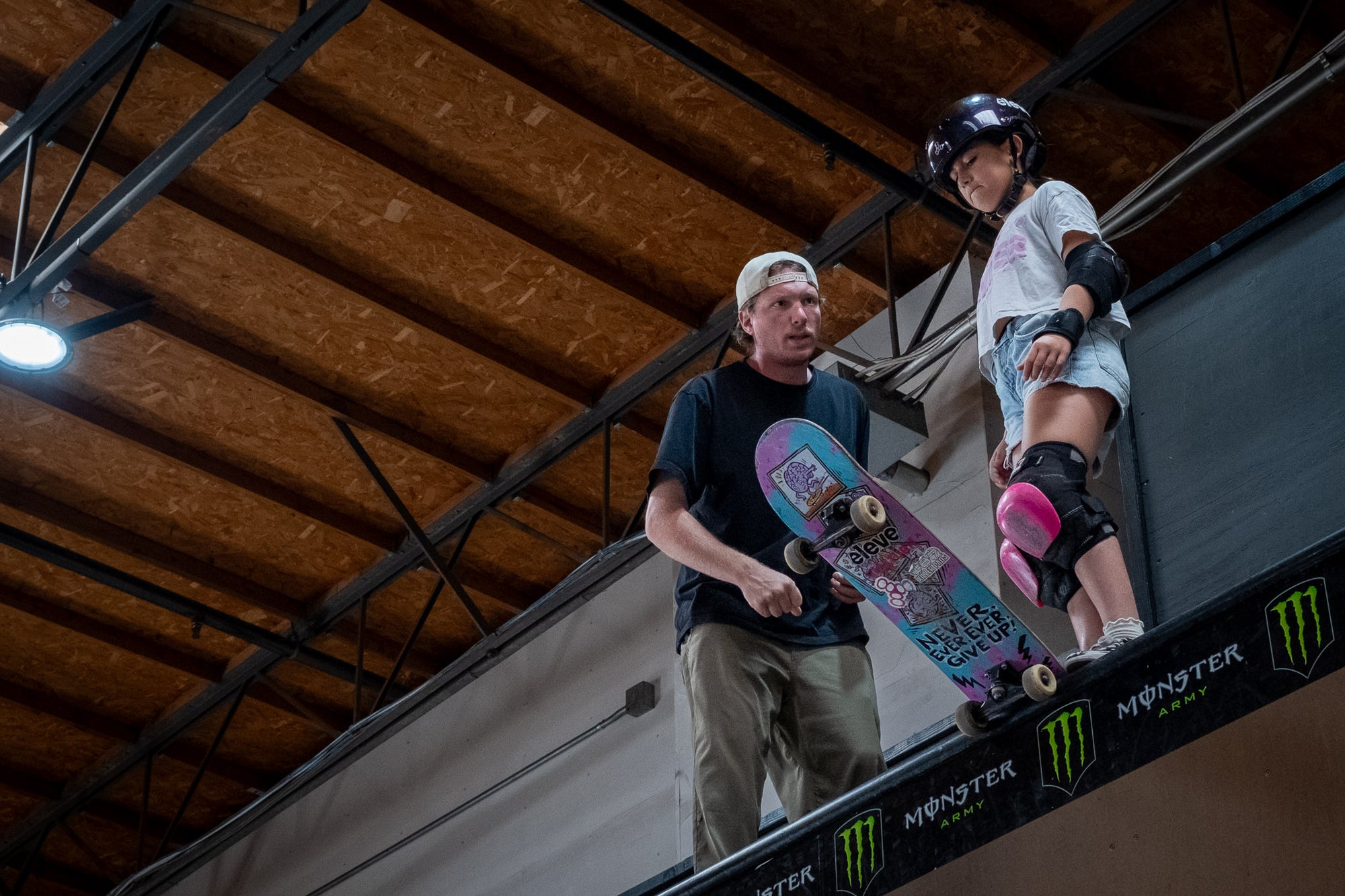 Maya, a Neuro team rider, listens to her coach before dropping into the vert ramp.