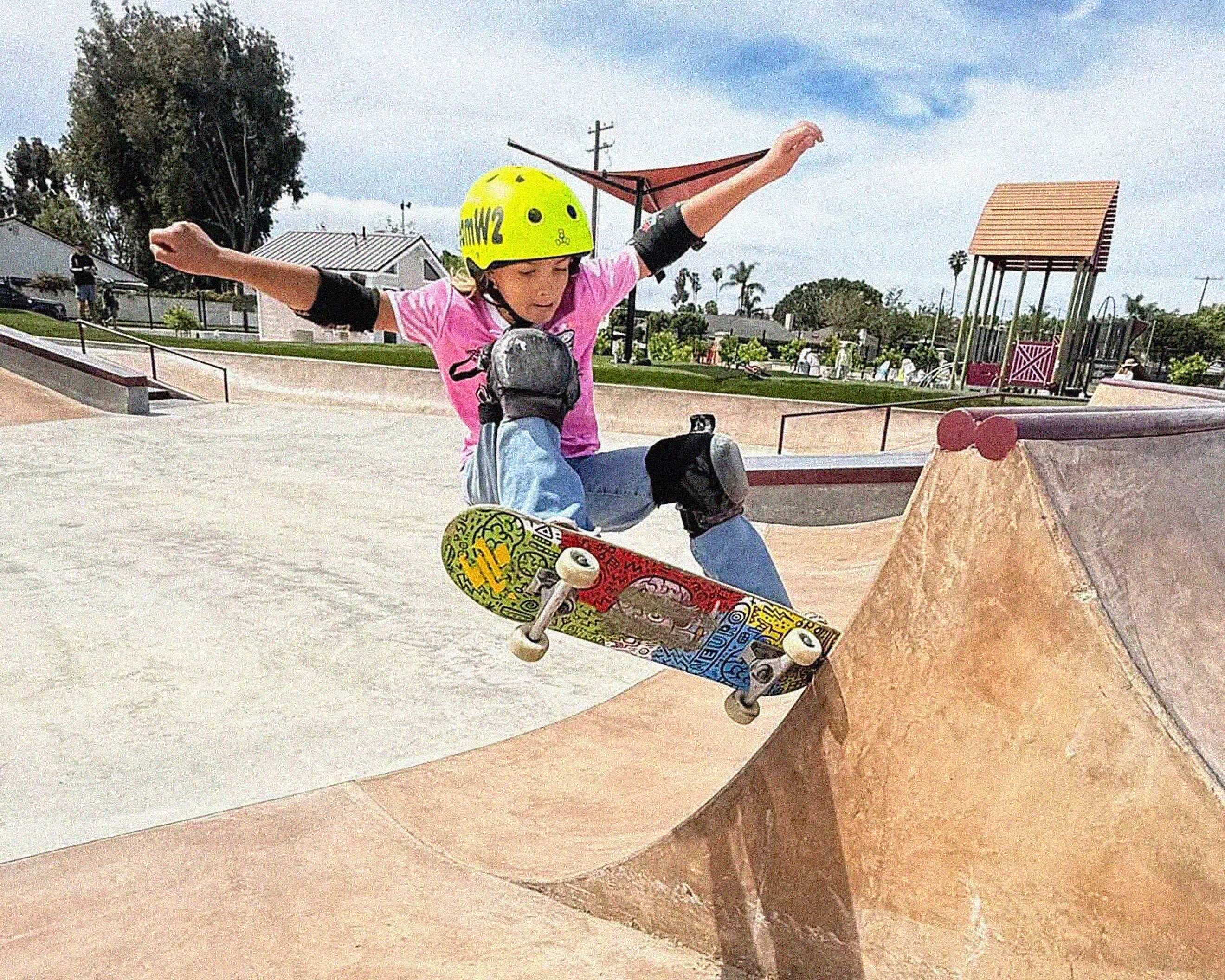 Young girl gets air off the edge of a quarter pipe while riding her Brain Love 8.0" skateboard.