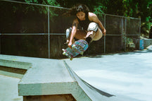 Coach Yvette gets air with her Never Give Up 8.5" while doing an early grab above a quarter pipe.