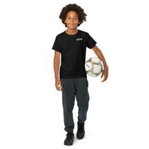 Child wearing the black Youth Neuro Logo tee and holding a soccer ball, full length view