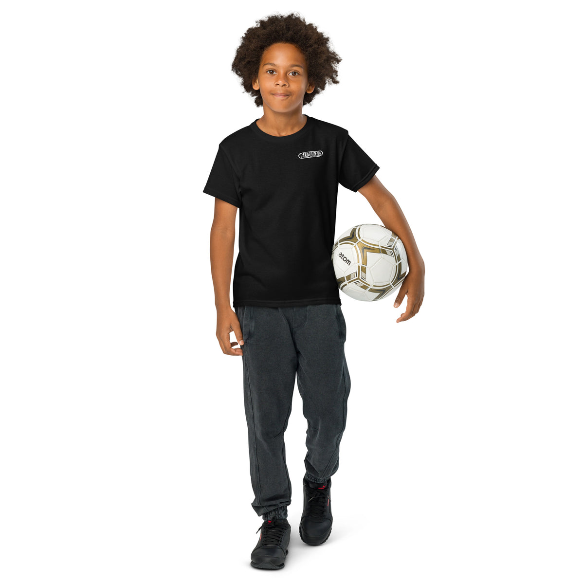 Child wearing the black Youth Neuro Logo tee and holding a soccer ball, full length view